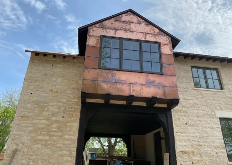 Copper metal panel facade on a stone building for Skylight Installation in Alsip