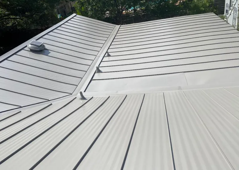Solar attic fan installed on a metal roof for Roof Ventilation in Alsip